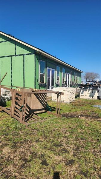 Rear view of property with a lawn