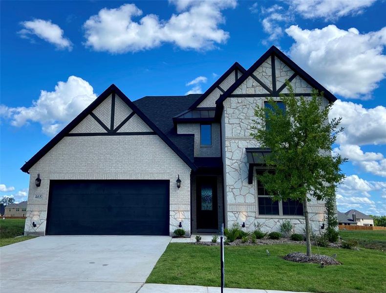 Gorgeous new home with white brick, white stone, and cedar & metal roofs accents. Gorgeous new home with white brick, white stone, and cedar & metal roofs accents.