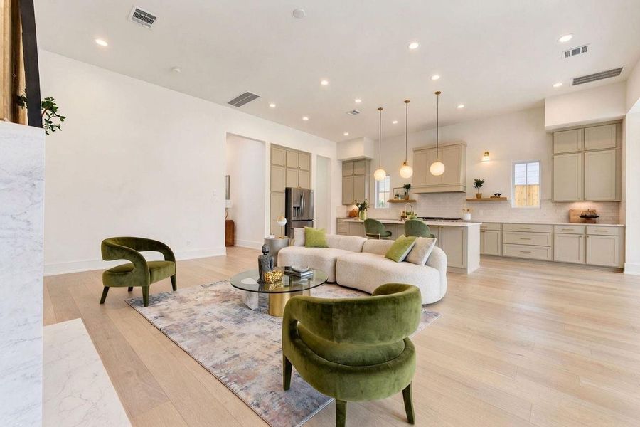 Expansive open-concept living and dining area showcasing beautiful French Oak floors, soaring ceilings, designer lighting, and abundant natural light. The seamless flow into the kitchen creates a bright, sophisticated space ideal for both everyday living and effortless entertaining. Expansive open-concept living and dining area showcasing beautiful French Oak floors, soaring ceilings, designer lighting, and abundant natural light. The seamless flow into the kitchen creates a bright, sophisticated space ideal for both everyday living and effortless entertaining.