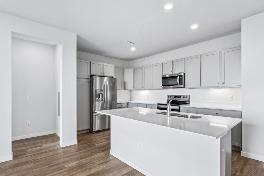 A kitchen with white cabinets.