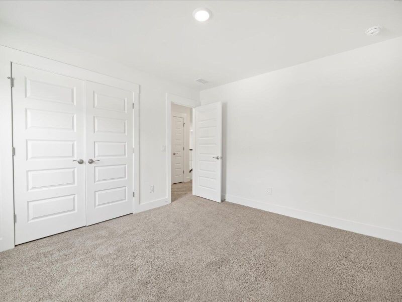 Spacious, unfurnished interior of a new home in The Coves at Lakes of Cane Bay, Summerville (Image 33).