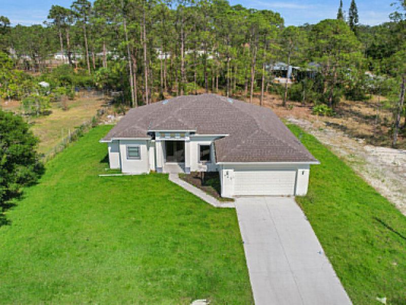 Front exterior of a new home in , Lehigh Acres, FL, highlighting curb appeal (Image 1). Front exterior of a new home in , Lehigh Acres, FL, highlighting curb appeal (Image 1).