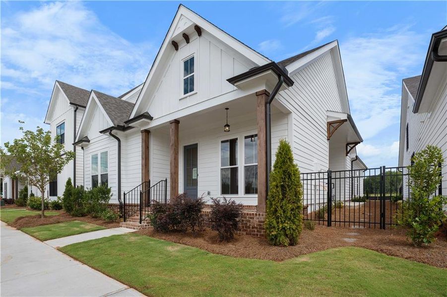 Front exterior of a new home in Promenade at Sawnee Village, Cumming, GA, highlighting curb appeal (Image 24). Front exterior of a new home in Promenade at Sawnee Village, Cumming, GA, highlighting curb appeal (Image 24).