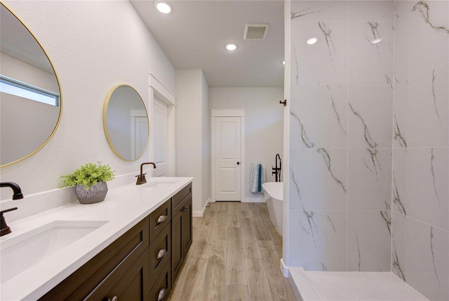 Beautiful master bathroom with double sink, spacious shower area (Shower doors have been installed already) and standalon tub.