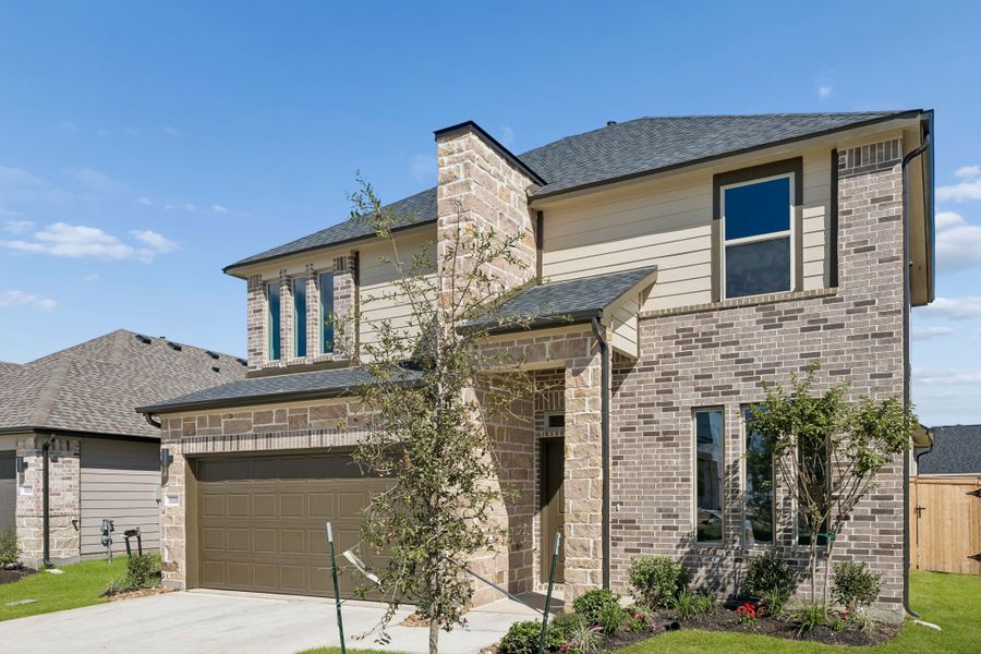 Front exterior of a new home in Riviera Pines, Huffman, TX, highlighting curb appeal (Image 20). Front exterior of a new home in Riviera Pines, Huffman, TX, highlighting curb appeal (Image 20).