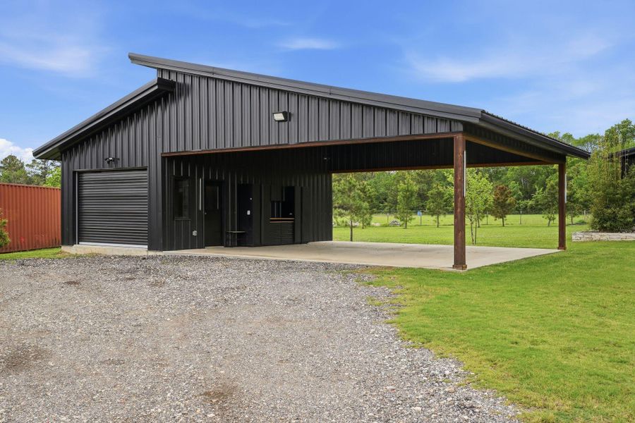 Detached carport with versatile shop, full bathroom and laundry room.