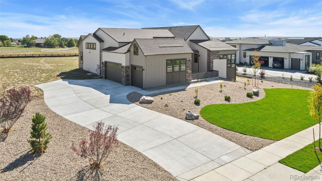 Front exterior of a new home in Acadia at RainDance, Windsor, CO, highlighting curb appeal (Image 16).