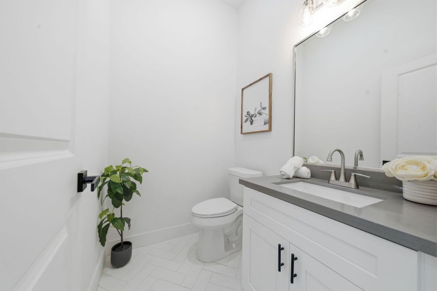 A half bath is conveniently located on the first floor, privately tucked behind the kitchen.