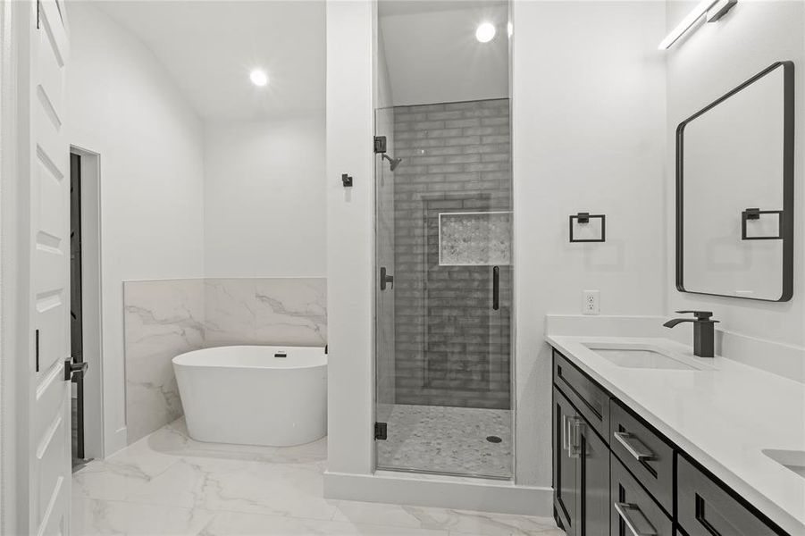 Bathroom with vanity, plus walk in shower, and tile walls