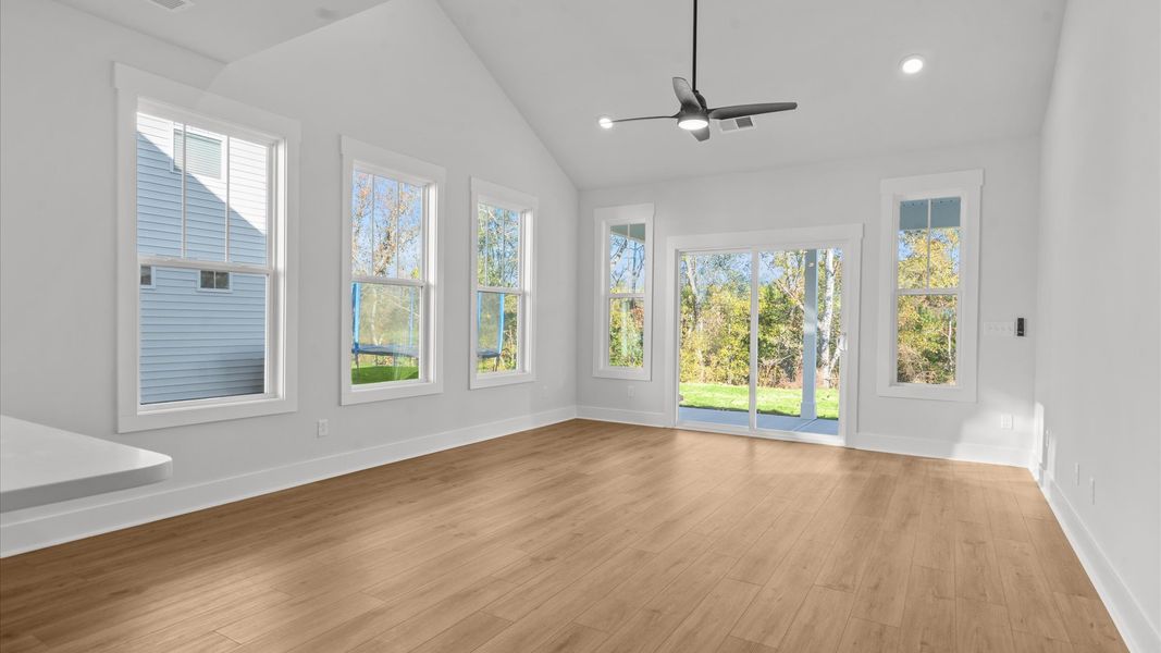 First-class living space featuring expansive ceilings, elegant design, and open sightlines to the kitchen First-class living space featuring expansive ceilings, elegant design, and open sightlines to the kitchen