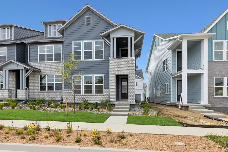 Front exterior of a new home in Kinston Mainstreet Townhomes, Loveland, CO, highlighting curb appeal (Image 1). Front exterior of a new home in Kinston Mainstreet Townhomes, Loveland, CO, highlighting curb appeal (Image 1).
