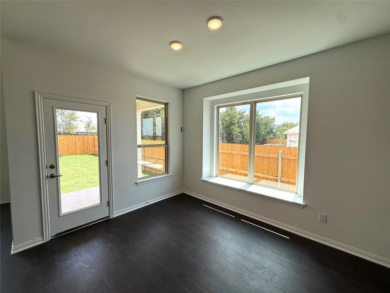 Doorway to outside with wood finished floors and baseboards Doorway to outside with wood finished floors and baseboards