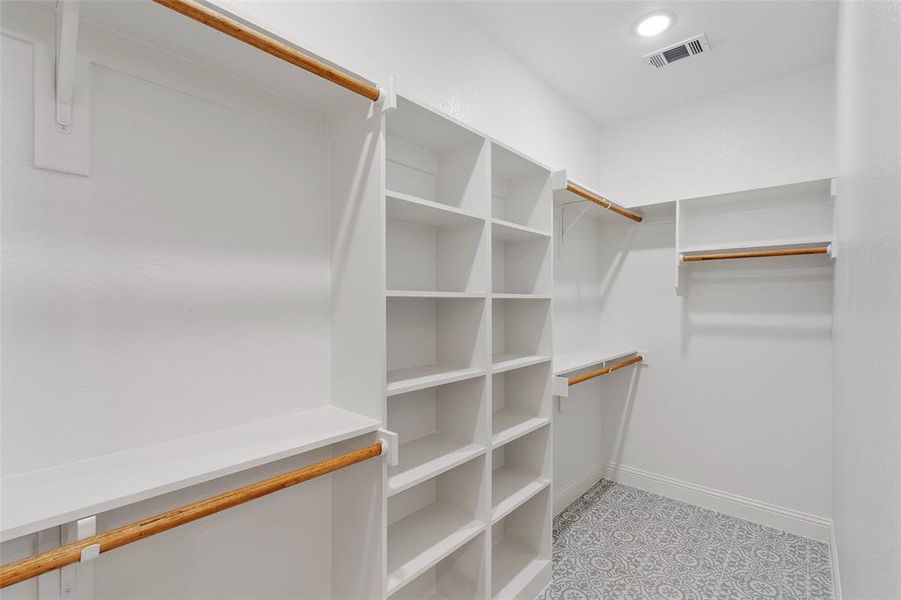 Spacious closet featuring light tile flooring