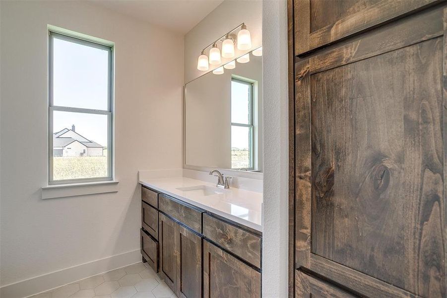 Bathroom with a wealth of natural light, tile flooring, and vanity