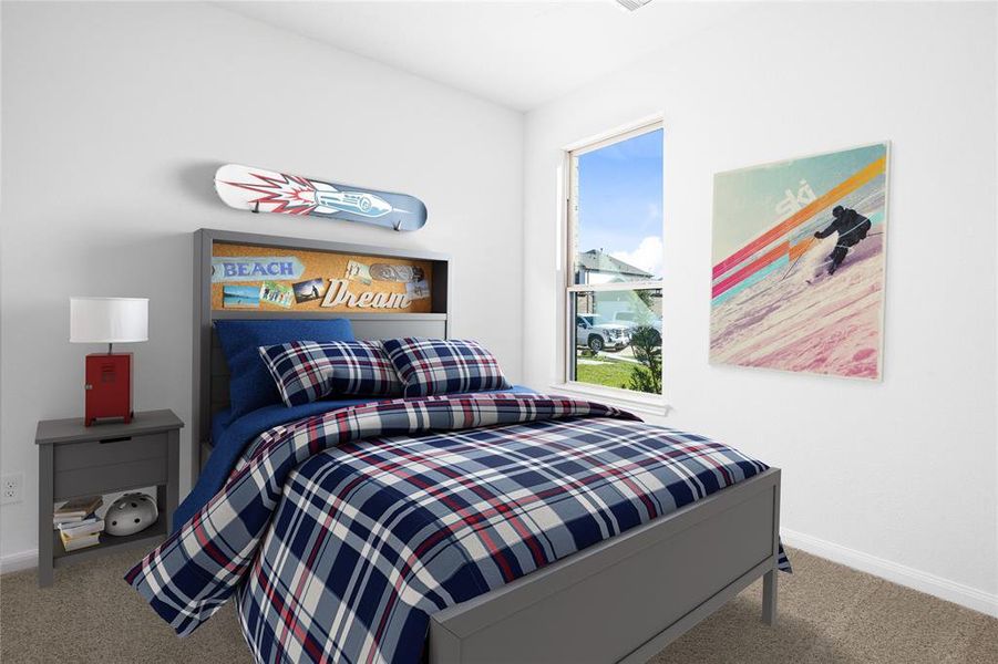 Secondary bedroom features plush carpet, custom paint, ample closet space, and a large window.