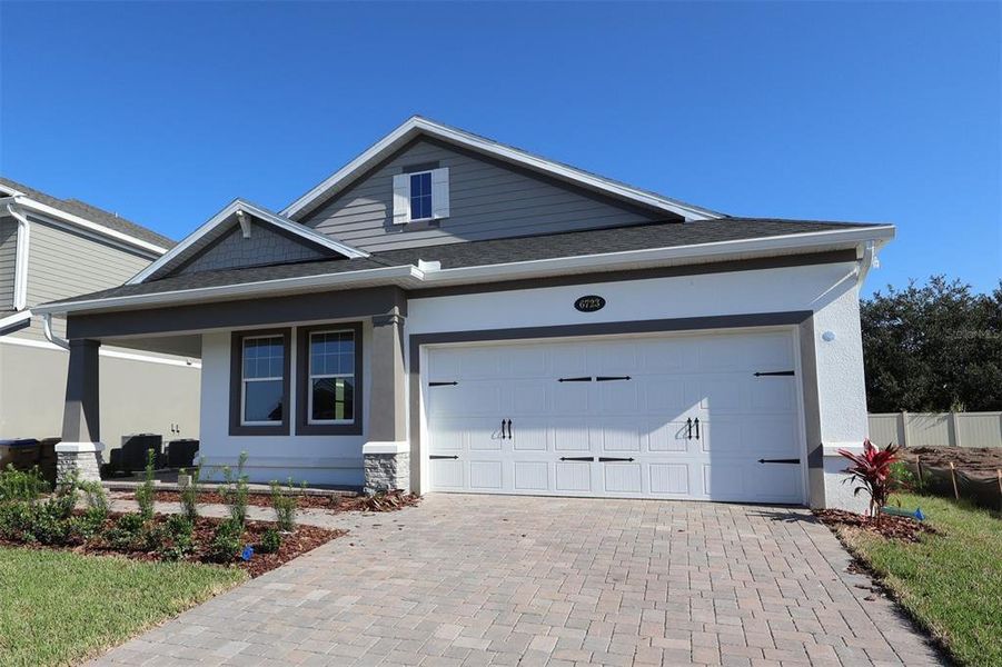Front exterior of a new home in Bay Lake Farms, St. Cloud, FL, highlighting curb appeal (Image 1).