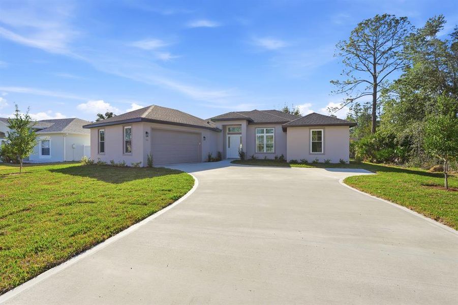 Front exterior of a new home in , Palm Coast, FL, highlighting curb appeal (Image 24).
