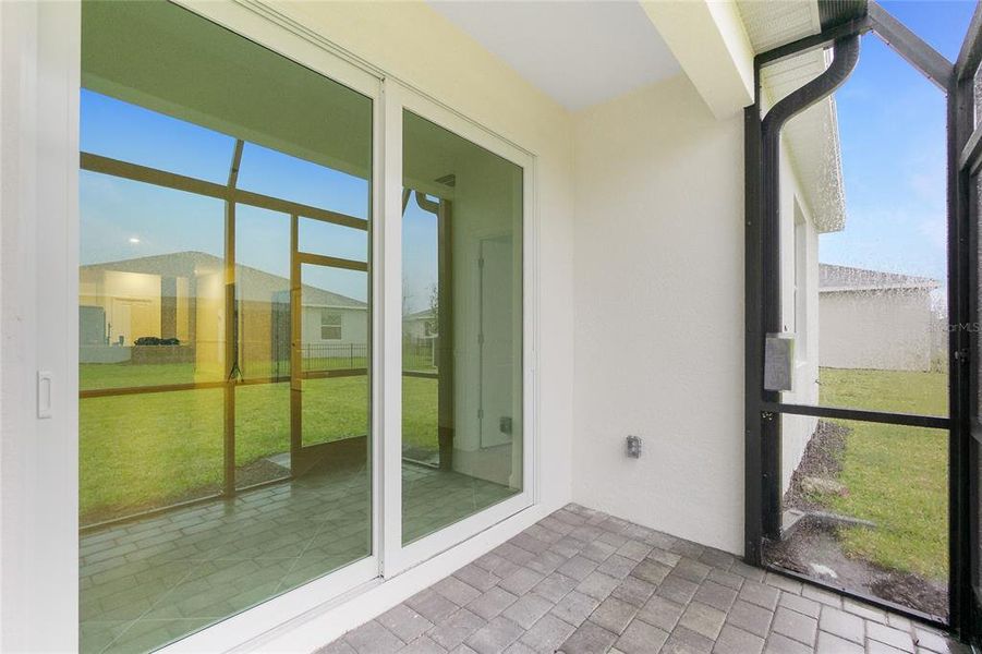 Exterior details and patio area of a home in Island Lakes at Coco Bay: Villas, Englewood (Image 3).