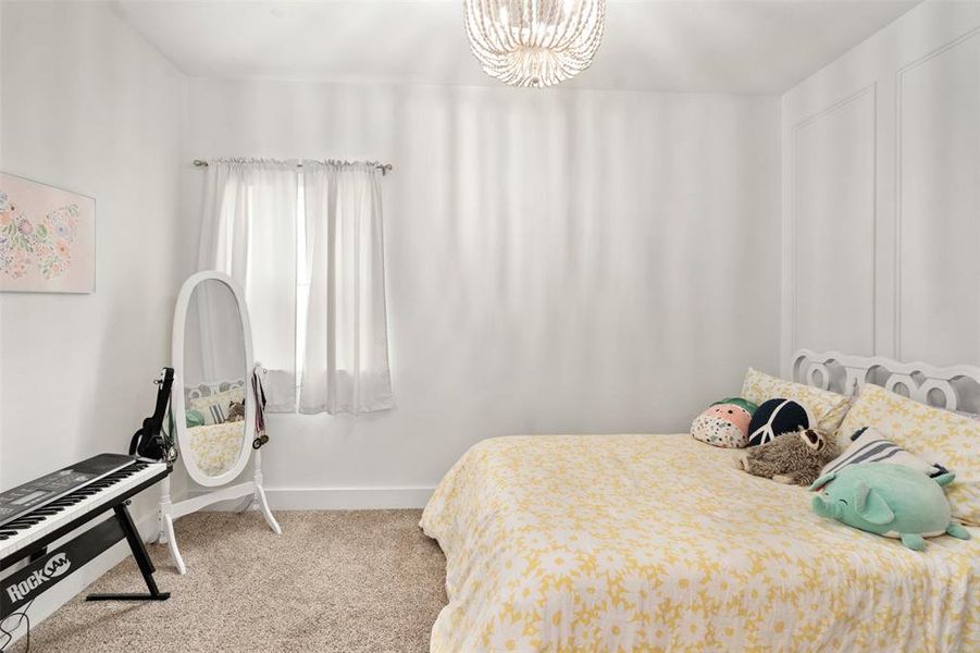 Bedroom featuring carpet and a chandelier
