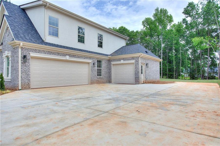 Front exterior of a new home in , Conyers, GA, highlighting curb appeal (Image 23). Front exterior of a new home in , Conyers, GA, highlighting curb appeal (Image 23).