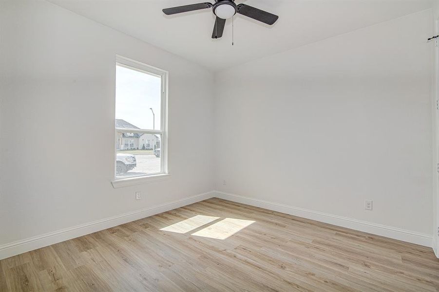 bedroom featuring light wood finished floors and a ceiling fan