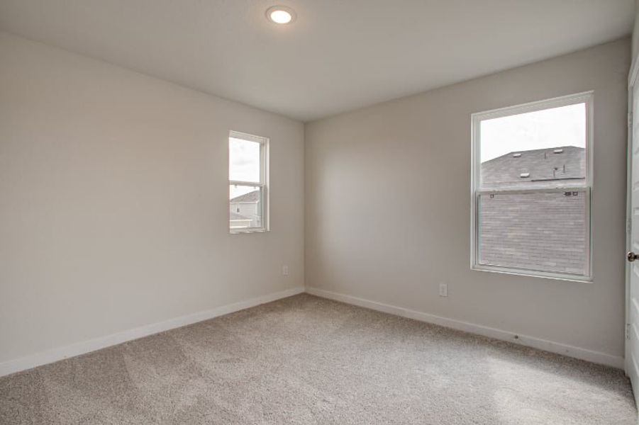 A room with a window and a carpet. A room with a window and a carpet.