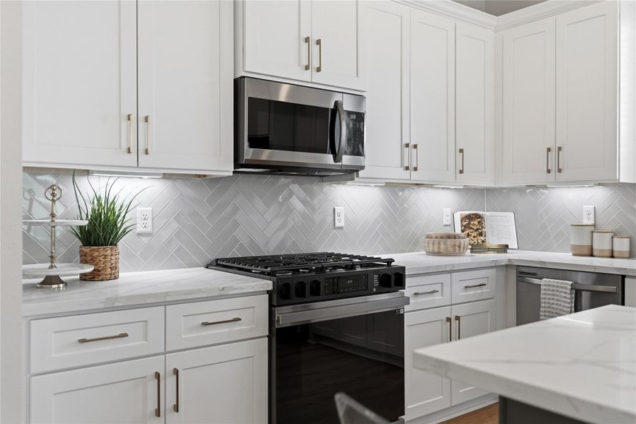A clean, modern herringbone backsplash paired with under mount lighting adds depth and dimension, enhancing both visibility and overall design continuity. A clean, modern herringbone backsplash paired with under mount lighting adds depth and dimension, enhancing both visibility and overall design continuity.