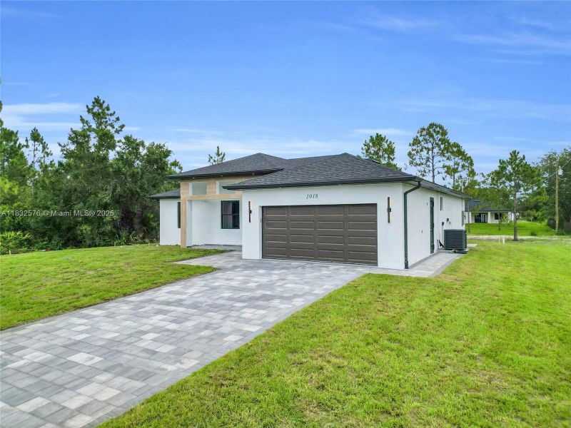 Front exterior of a new home in , Lehigh Acres, FL, highlighting curb appeal (Image 30).