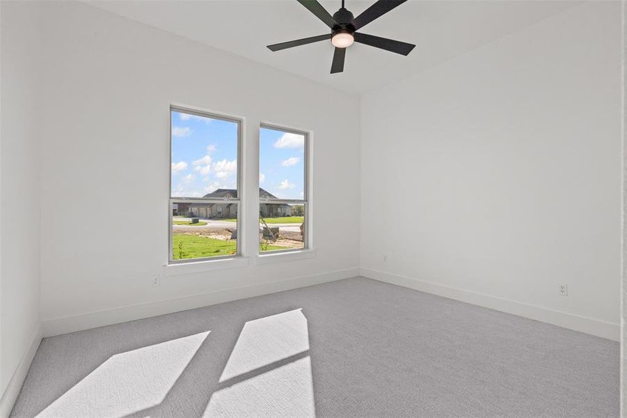 Empty room with carpet and ceiling fan
