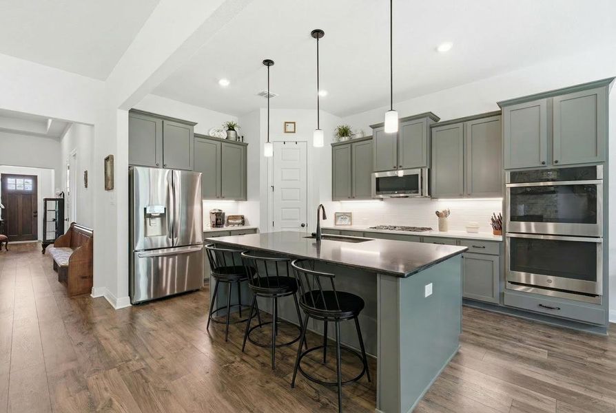 Culinary dreams come to life in this kitchen, featuring an eat-in island, stainless steel appliances, and abundant cabinetry. Culinary dreams come to life in this kitchen, featuring an eat-in island, stainless steel appliances, and abundant cabinetry.