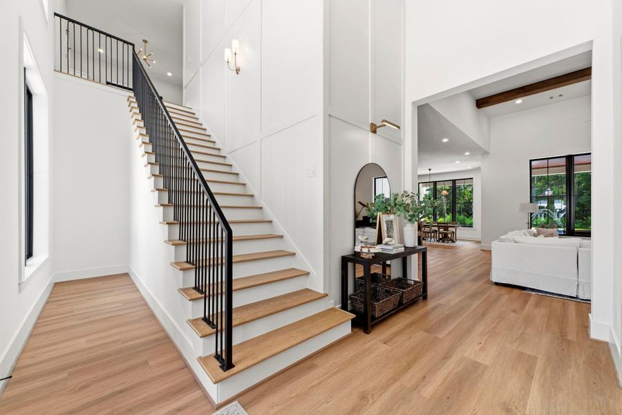 Wow Factory entry with high ceilings, natural light, and White oak wood stair treads with custom iron railing. Wow Factory entry with high ceilings, natural light, and White oak wood stair treads with custom iron railing.