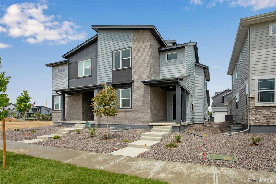 Front exterior of a new home in Sugar Mill Village, Longmont, CO, highlighting curb appeal (Image 20). Front exterior of a new home in Sugar Mill Village, Longmont, CO, highlighting curb appeal (Image 20).