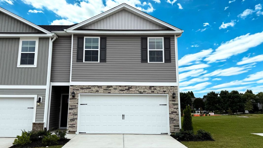Front exterior of a new home in Brightwood Farm, Whitsett, NC, highlighting curb appeal (Image 1). Front exterior of a new home in Brightwood Farm, Whitsett, NC, highlighting curb appeal (Image 1).