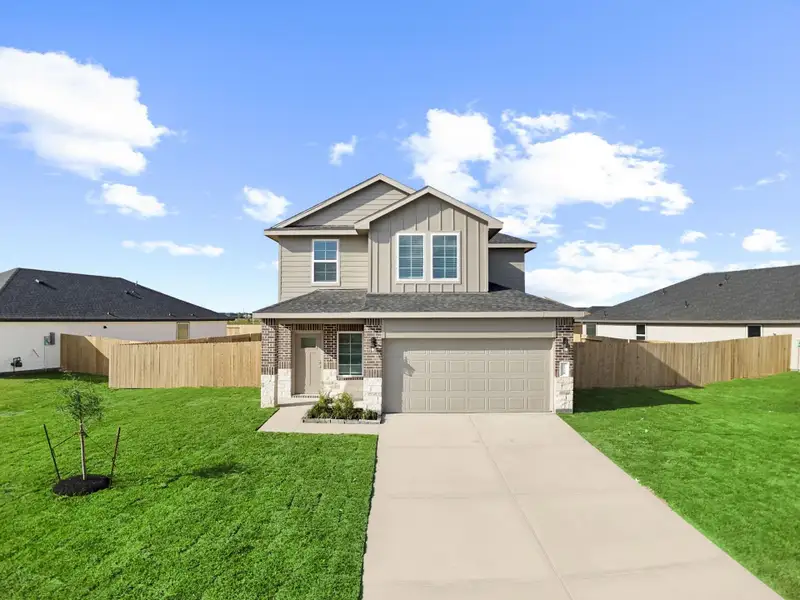 Front exterior of a new home in Watermark, Alvin, TX, highlighting curb appeal (Image 1). Front exterior of a new home in Watermark, Alvin, TX, highlighting curb appeal (Image 1).
