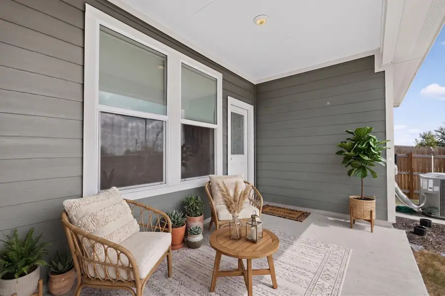 A sheltered back porch offers a concrete floor and horizontal siding panels. A sheltered back porch offers a concrete floor and horizontal siding panels.