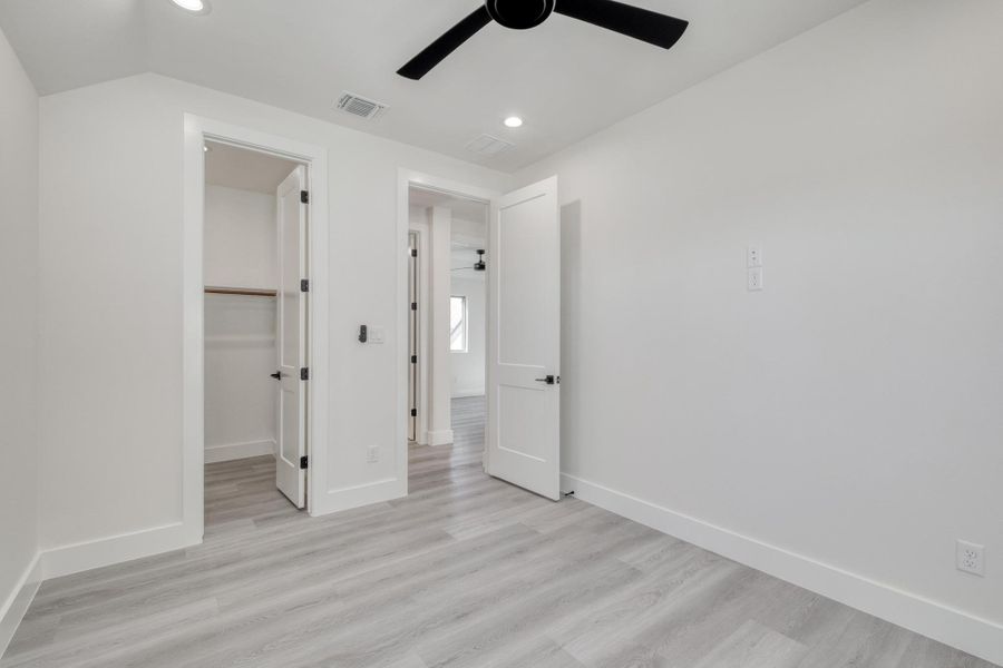 Unfurnished bedroom featuring visible vents, baseboards, and light wood finished floors