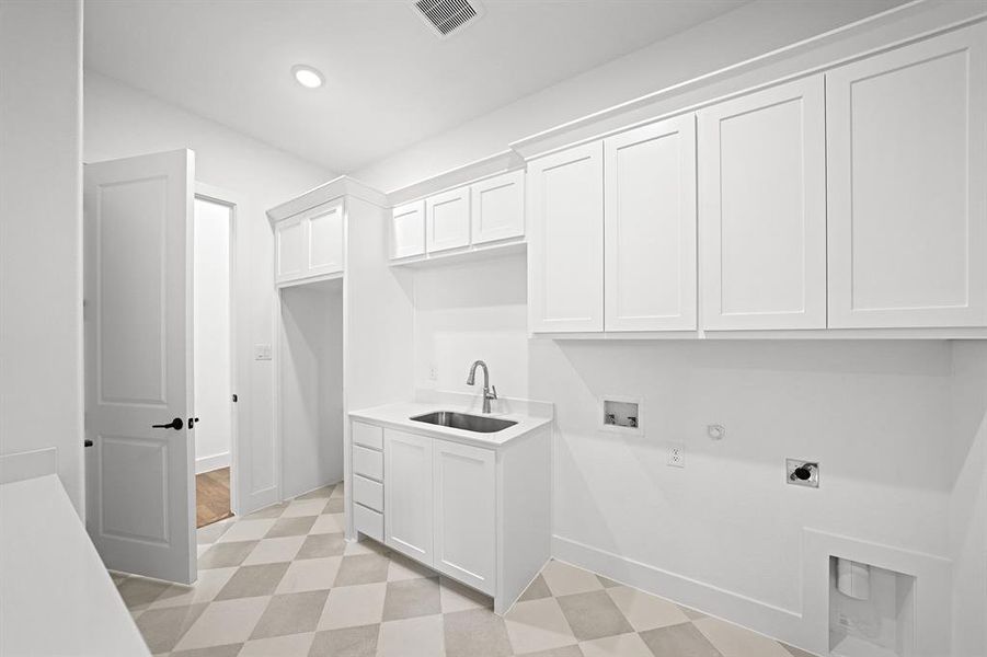Laundry area featuring light flooring, gas dryer hookup, washer hookup, hookup for an electric dryer, and cabinet space