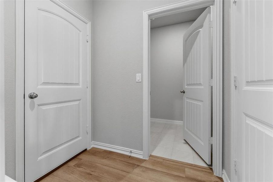 Hallway featuring baseboards and light wood-style flooring