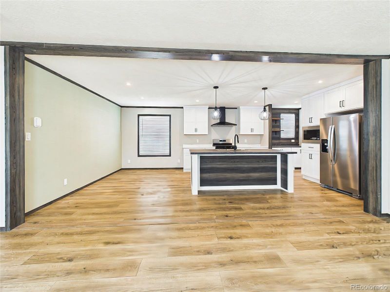 Kitchen & Dining Area – Contemporary kitchen with a large island, pendant lighting, and stainless steel appliances, paired with a dedicated dining space perfect for gatherings.