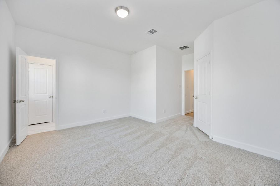 Let the sunlight pour in. This secondary bedroom feels anything but secondary with its spacious layout and warm energy.