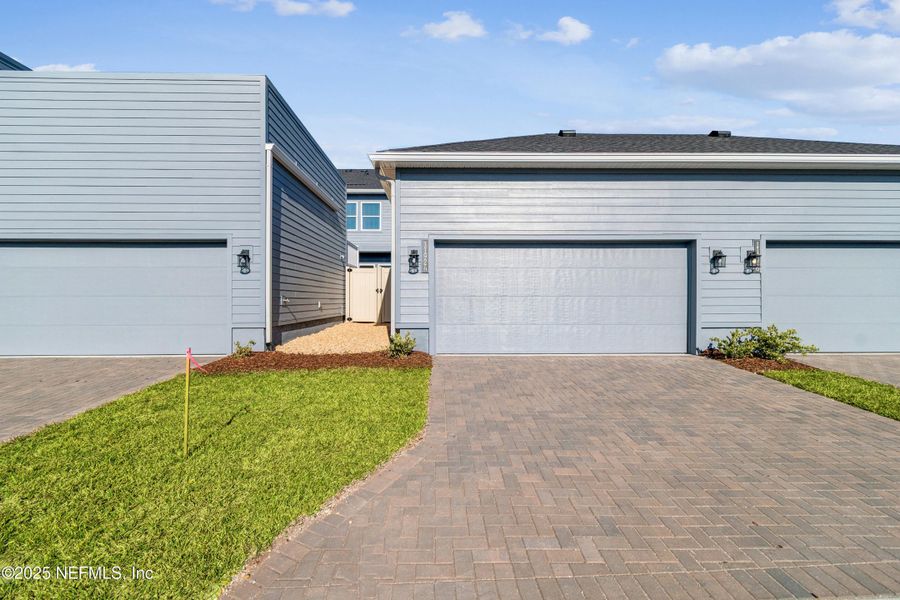 Exterior details and patio area of a home in Seven Pines 24' Rear Entry Townhomes, Jacksonville (Image 20).