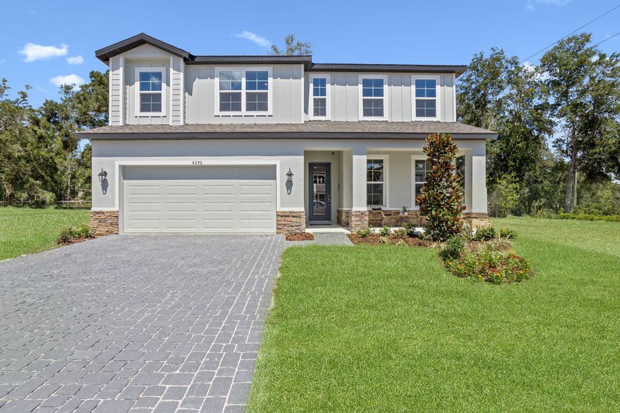 Front exterior of a new home in Estes Reserve, Eustis, FL, highlighting curb appeal (Image 20).