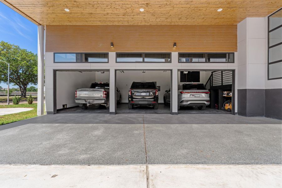 This expansive three-car garage features full-depth bays with room for vehicles of any size.