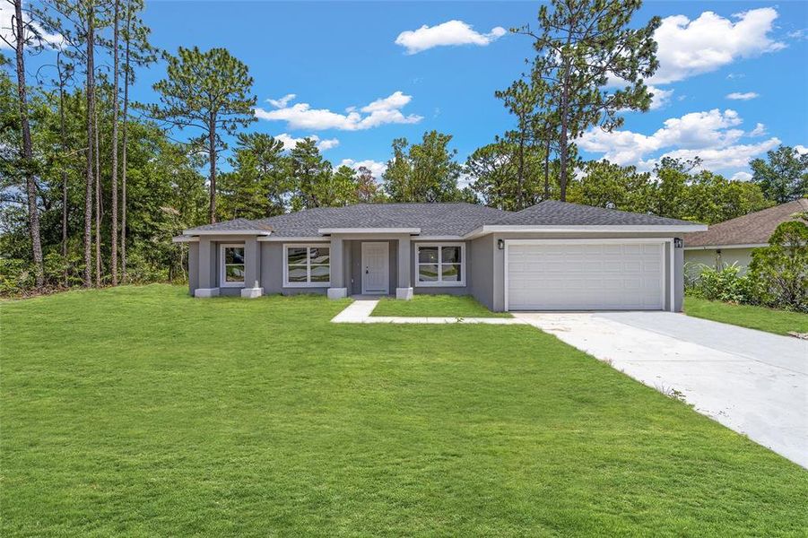 Front exterior of a new home in , Dunnellon, FL, highlighting curb appeal (Image 6).