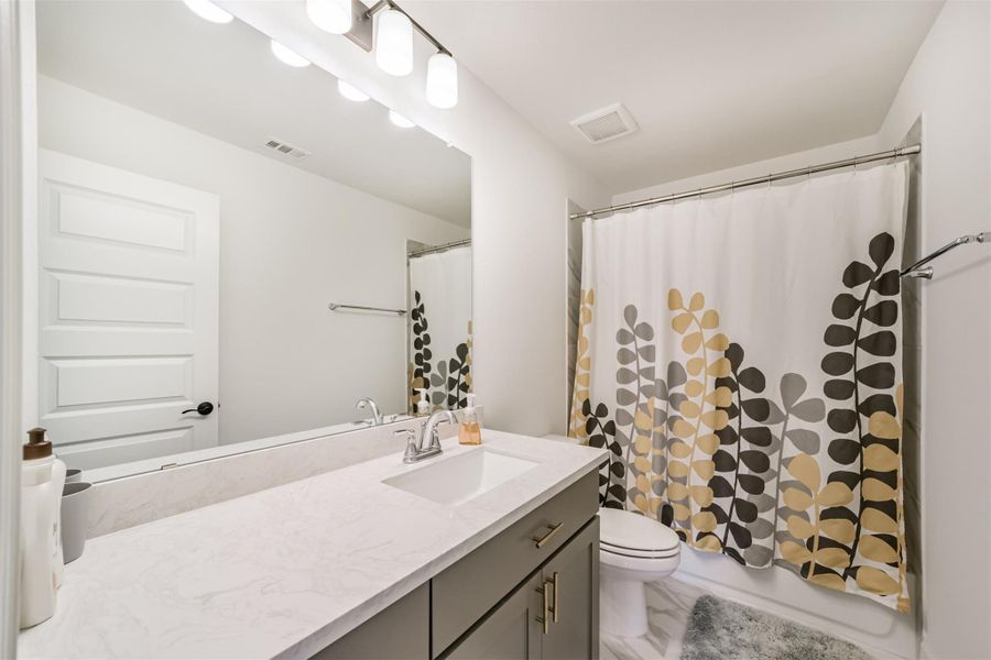 The fourth upstairs bedroom features a sleek quartz countertop with an undermount sink, complemented by a tub/shower enclosed in elegant ceramic tile. The fourth upstairs bedroom features a sleek quartz countertop with an undermount sink, complemented by a tub/shower enclosed in elegant ceramic tile.