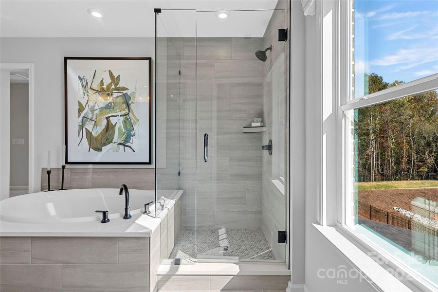 Semi-frameless walk-in shower with tile pan and premium design.