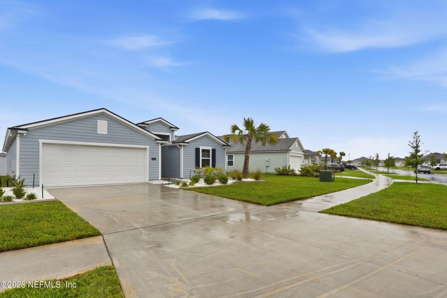 Front exterior of a new home in Cross Creek, Green Cove Springs, FL, highlighting curb appeal (Image 21).