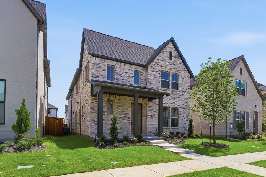 Front exterior of a new home in Light Farms Brenham - 40' Lots, Celina, TX, highlighting curb appeal (Image 25). Front exterior of a new home in Light Farms Brenham - 40' Lots, Celina, TX, highlighting curb appeal (Image 25).