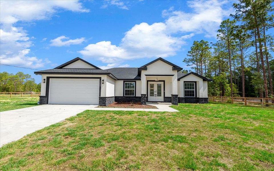 Front exterior of a new home in , Dunnellon, FL, highlighting curb appeal (Image 27). Front exterior of a new home in , Dunnellon, FL, highlighting curb appeal (Image 27).