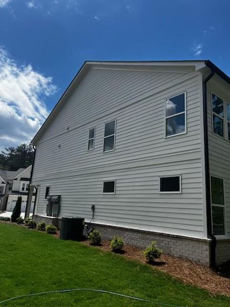 Front exterior of a new home in Riversong, Duluth, GA, highlighting curb appeal (Image 16).